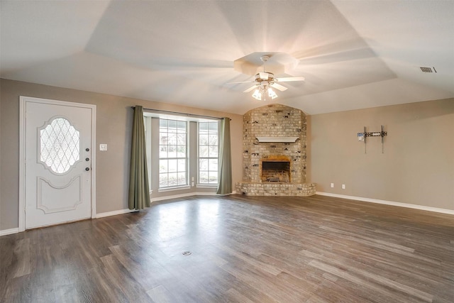 unfurnished living room with ceiling fan, lofted ceiling, dark hardwood / wood-style floors, and a fireplace