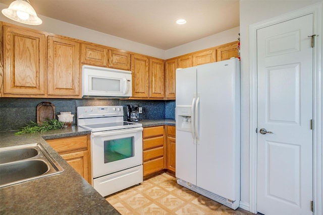 kitchen featuring sink, white appliances, decorative light fixtures, and backsplash