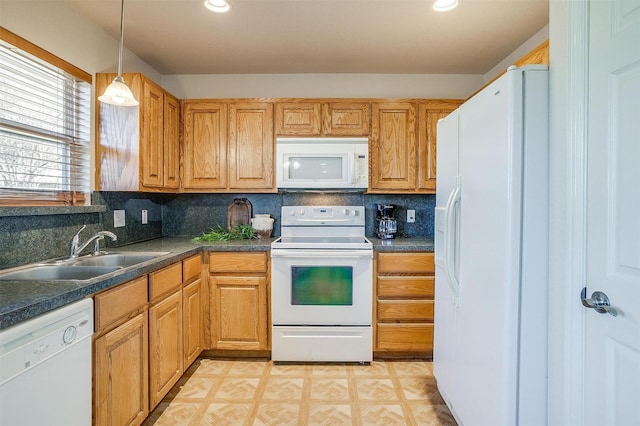 kitchen featuring sink, white appliances, decorative backsplash, and decorative light fixtures