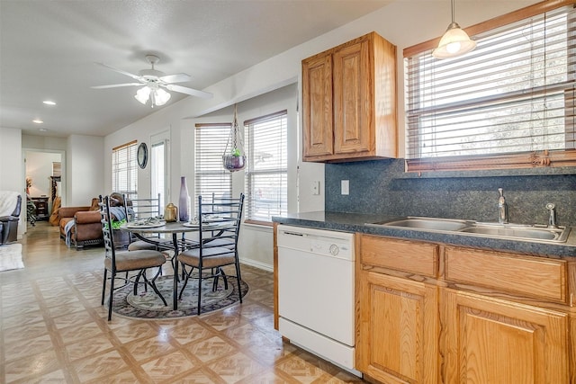 kitchen featuring dishwasher, ceiling fan, decorative backsplash, sink, and decorative light fixtures