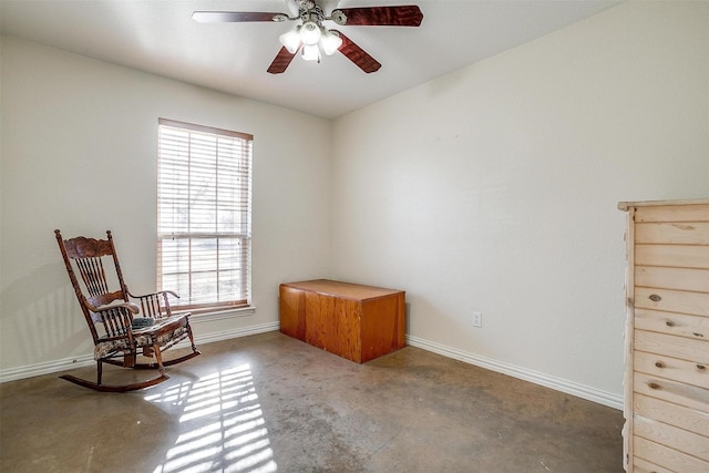 living area featuring ceiling fan and a healthy amount of sunlight