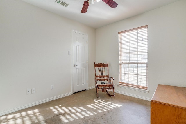 living area featuring ceiling fan and a wealth of natural light