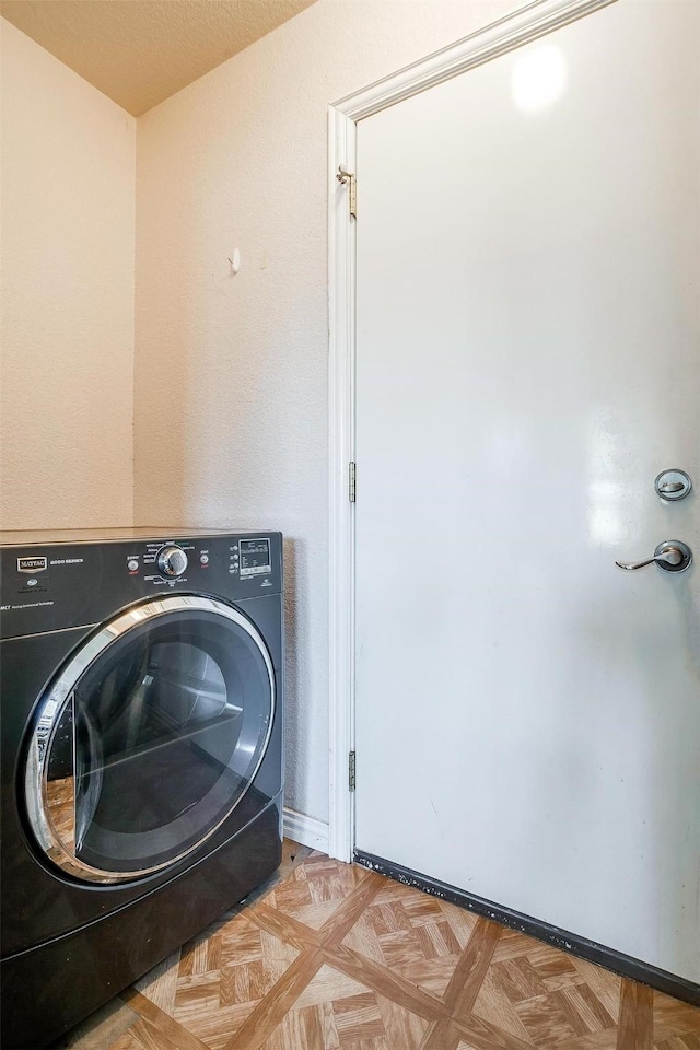 laundry area featuring washer / clothes dryer and light parquet flooring