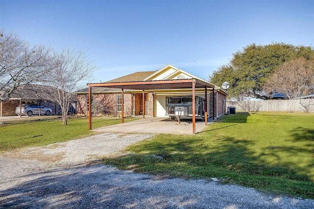 exterior space with a carport and a front lawn