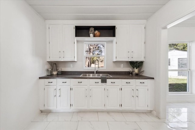 kitchen featuring sink, white cabinets, and a healthy amount of sunlight