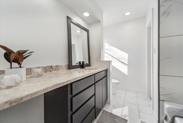 bathroom featuring toilet, a shower, and vanity