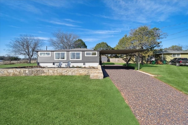 view of front facade with a carport and a front lawn