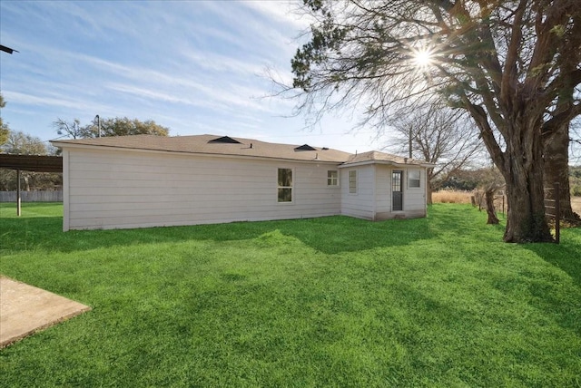 rear view of property with a yard