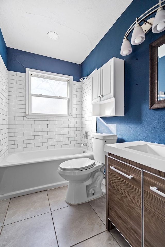 full bathroom with vanity, tiled shower / bath combo, tile patterned floors, and toilet