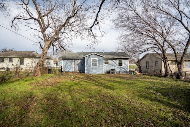 back of property with a lawn