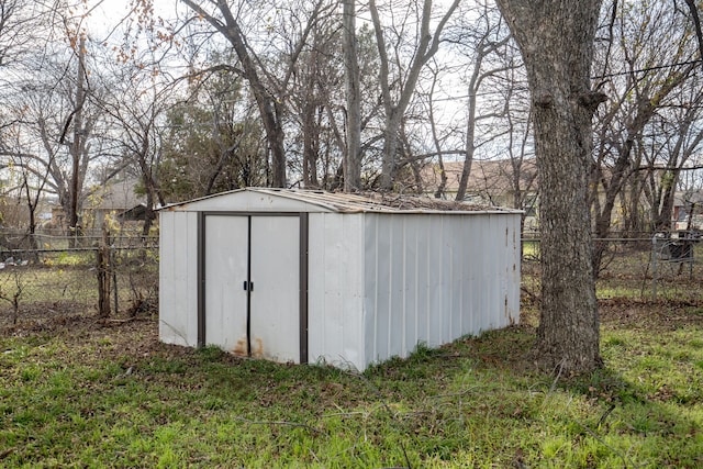 view of outbuilding featuring a lawn