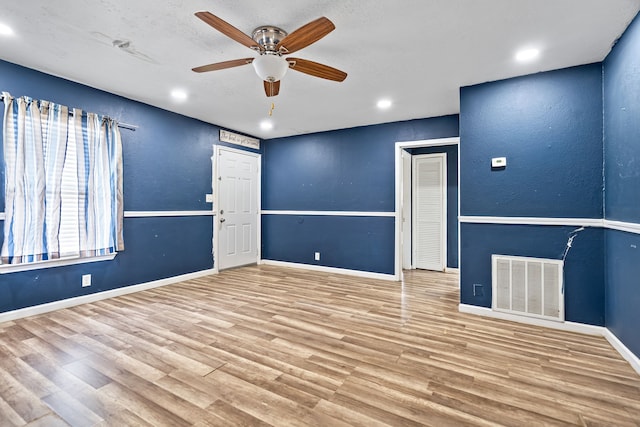 unfurnished room with ceiling fan and light wood-type flooring