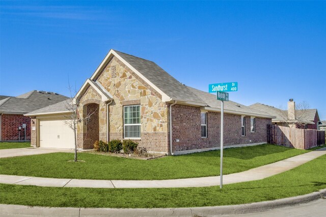 view of front facade with a front yard and a garage