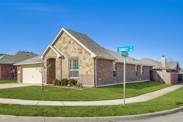 view of front facade with a garage, stone siding, brick siding, and a front lawn