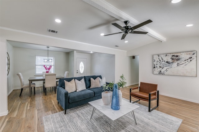 living room with lofted ceiling with beams, ceiling fan, and light wood-type flooring