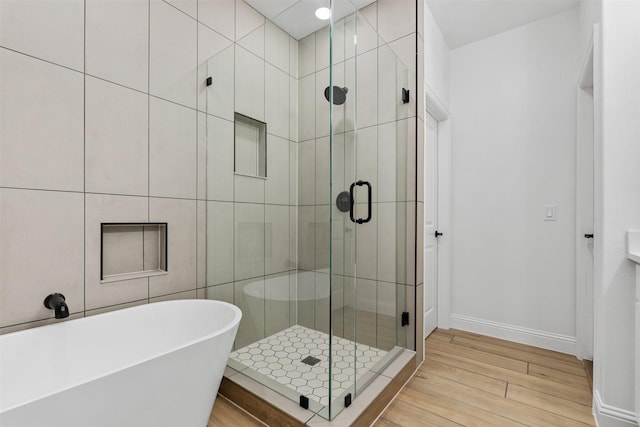 bathroom featuring shower with separate bathtub