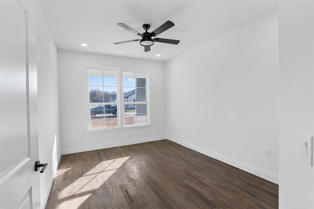 spare room with ceiling fan and dark hardwood / wood-style floors