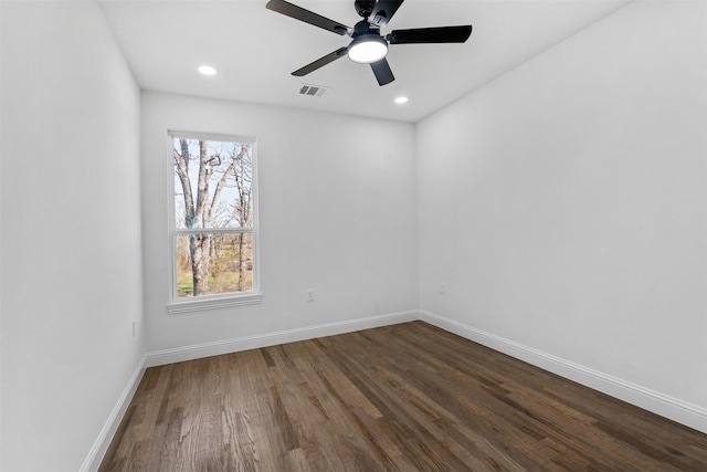 spare room with ceiling fan and dark hardwood / wood-style floors