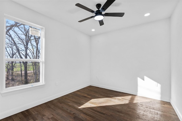 unfurnished room with hardwood / wood-style floors, ceiling fan, and a healthy amount of sunlight