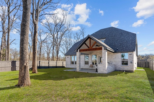 back of house featuring a lawn and a patio