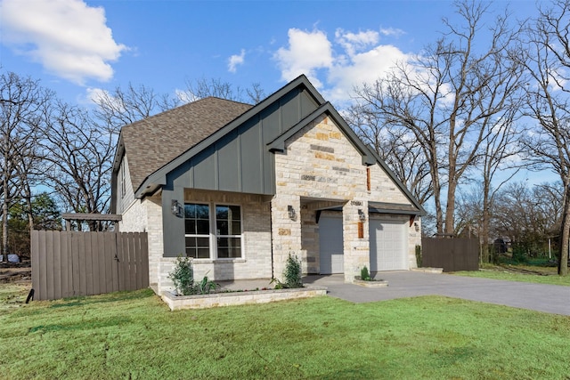 view of front of house featuring a front yard and a garage