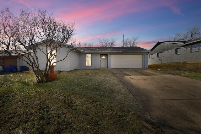 single story home featuring a yard and a garage