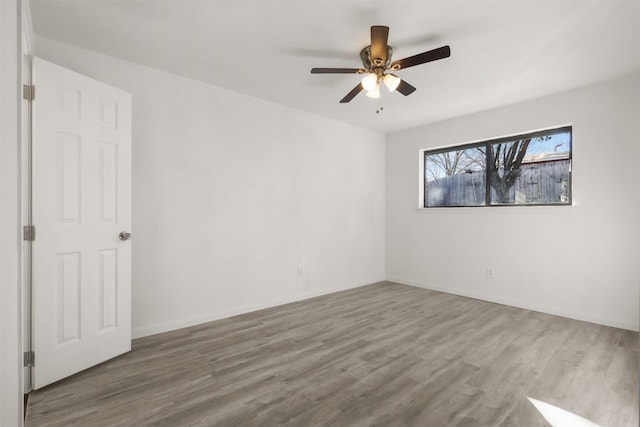 empty room featuring ceiling fan and hardwood / wood-style flooring