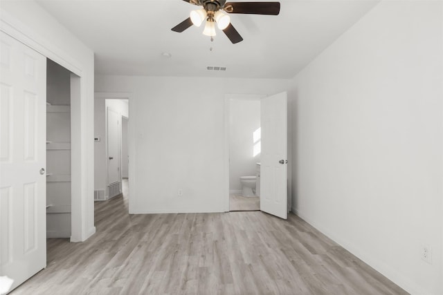 unfurnished bedroom with ceiling fan, light hardwood / wood-style flooring, connected bathroom, and a closet