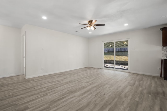 unfurnished living room featuring light wood-type flooring and ceiling fan