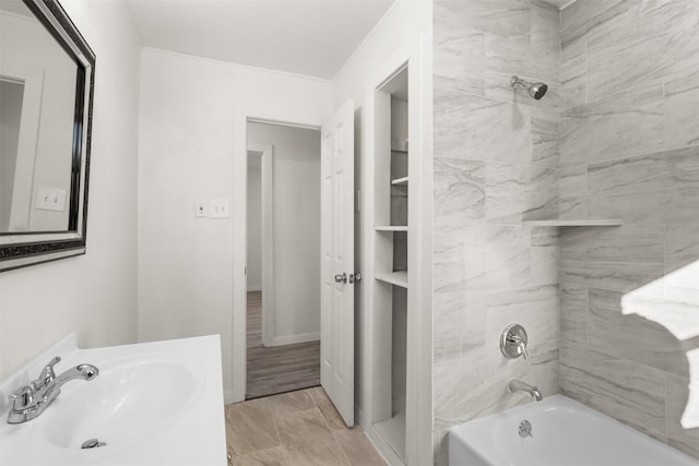 bathroom featuring sink and tiled shower / bath combo