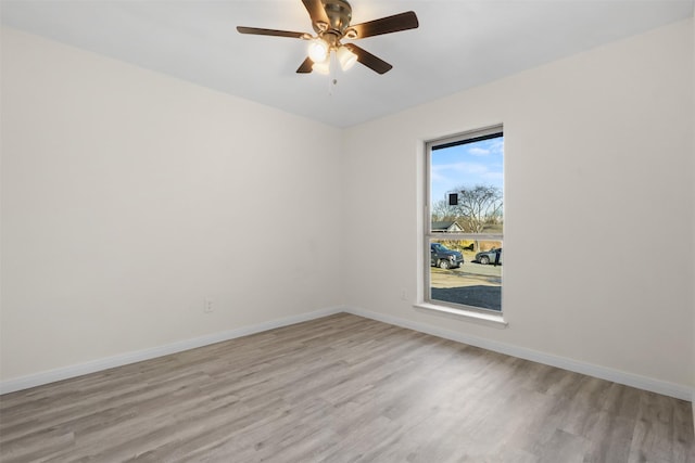 empty room with ceiling fan and light wood-type flooring