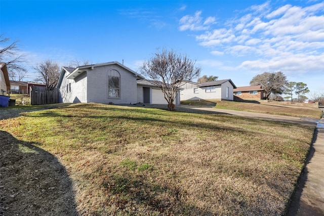 view of front of property with a front yard and a garage