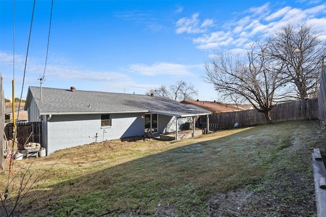 rear view of house with a lawn