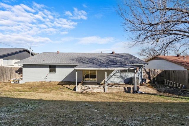 rear view of property featuring a yard and a patio