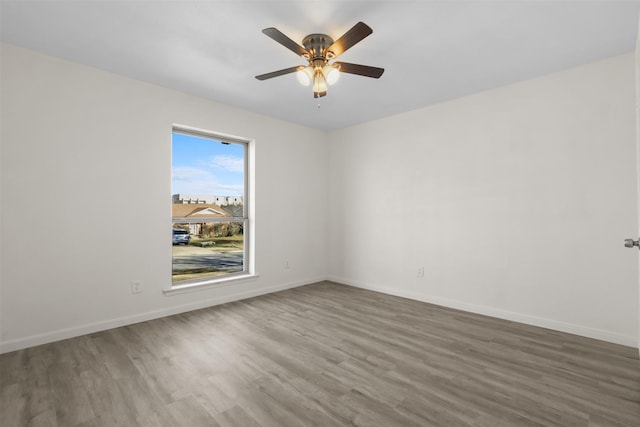 spare room with wood-type flooring and ceiling fan