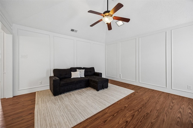 living room with ceiling fan, lofted ceiling, and dark hardwood / wood-style flooring