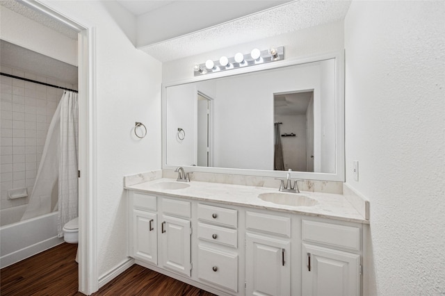 full bathroom with toilet, wood-type flooring, shower / bathtub combination with curtain, and vanity