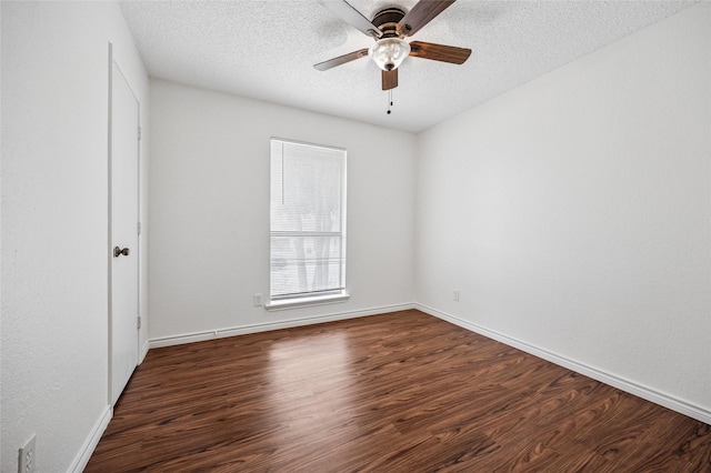 empty room with ceiling fan, a textured ceiling, and dark hardwood / wood-style flooring