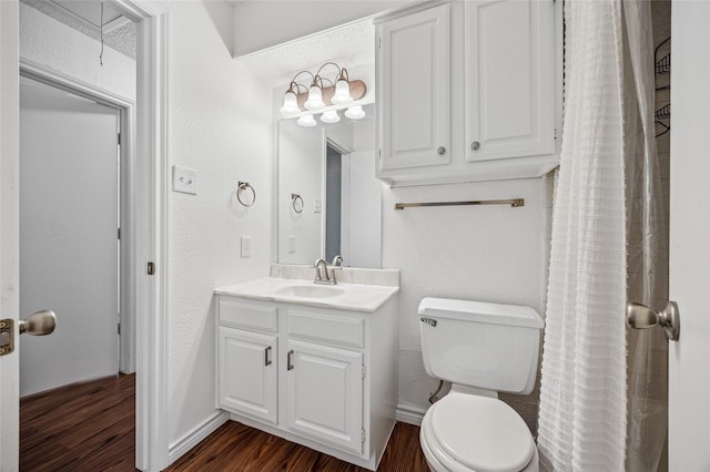 bathroom featuring hardwood / wood-style flooring, vanity, and toilet