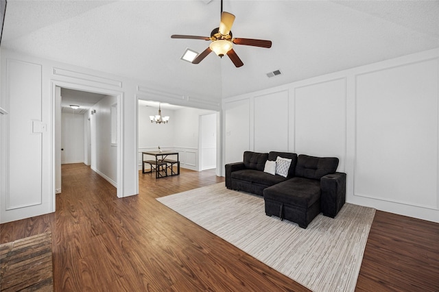 living room with lofted ceiling, dark hardwood / wood-style floors, and ceiling fan with notable chandelier