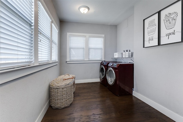 clothes washing area featuring dark wood-type flooring and washer and clothes dryer