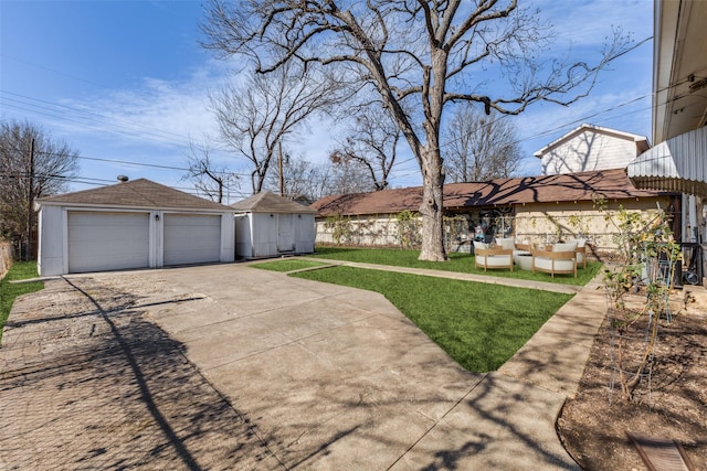 view of yard with a garage and an outdoor structure