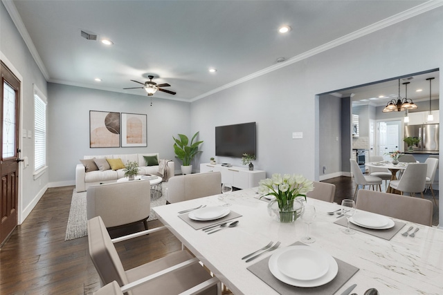 dining area featuring ornamental molding, dark hardwood / wood-style floors, and ceiling fan with notable chandelier