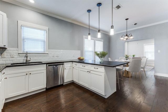 kitchen featuring sink, decorative light fixtures, stainless steel dishwasher, and white cabinets