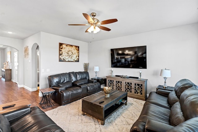 living room featuring ceiling fan and hardwood / wood-style floors