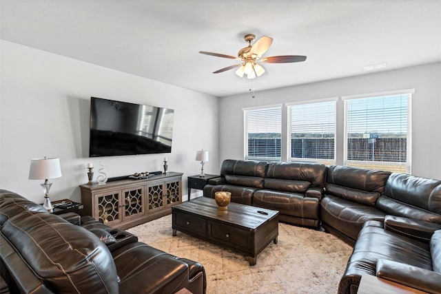 living room featuring ceiling fan and a healthy amount of sunlight