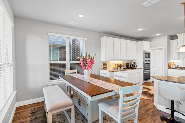 dining area with dark wood-type flooring