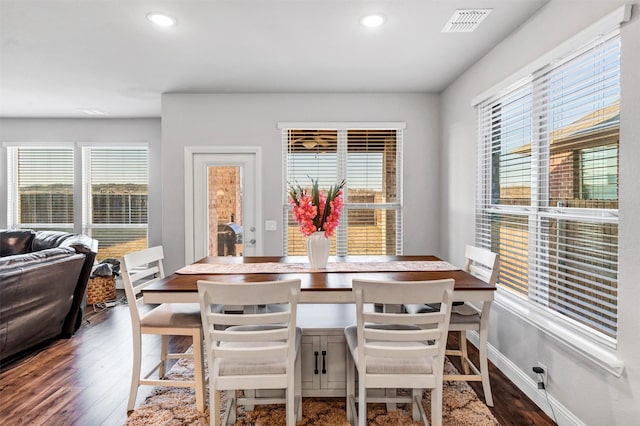 dining space featuring dark hardwood / wood-style flooring and breakfast area