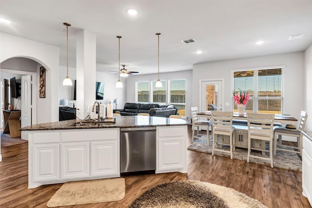 kitchen with sink, white cabinetry, dishwasher, ceiling fan, and dark stone counters