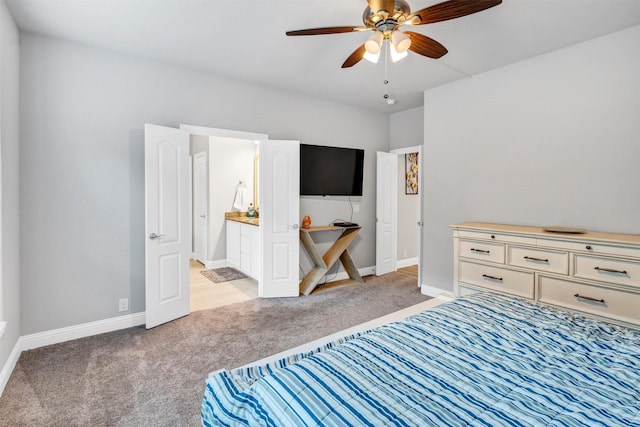 carpeted bedroom featuring ceiling fan and connected bathroom